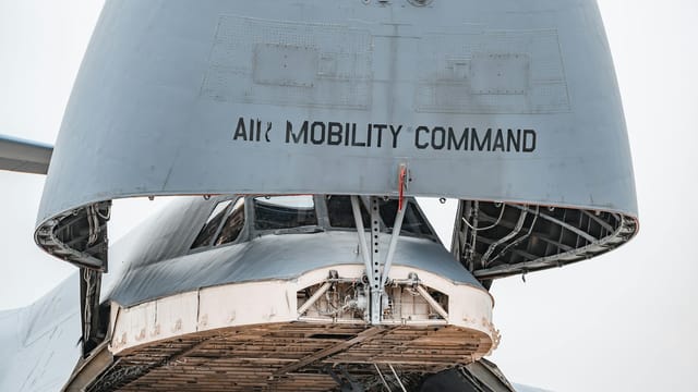 Close-up view of a military cargo aircraft with its bay open, displaying Air Mobility Command.