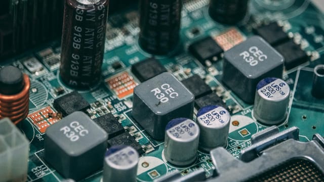 Detailed view of electronic components on a circuit board showcasing capacitors and semiconductors.