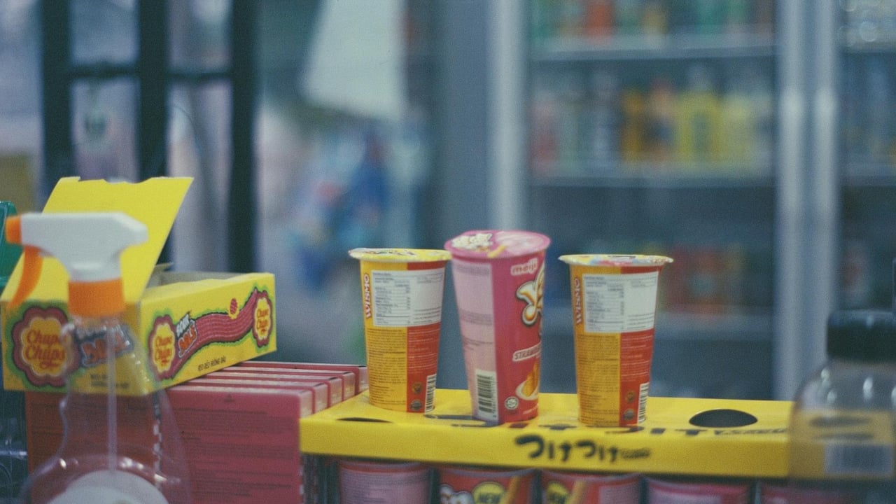 Close-up of various snacks and Yan Yan chocolate sticks in a convenience store setting.