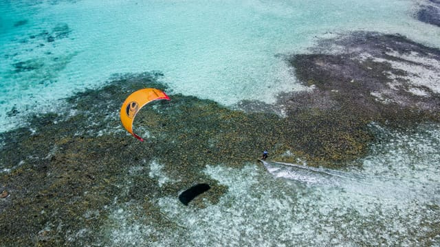 A thrilling kitesurfing scene on the vibrant blue waters of Dependencias Federales, Venezuela.