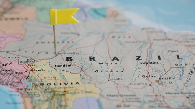 Close-up view of a map with a yellow pin marking a location in Brazil, highlighting the geography.