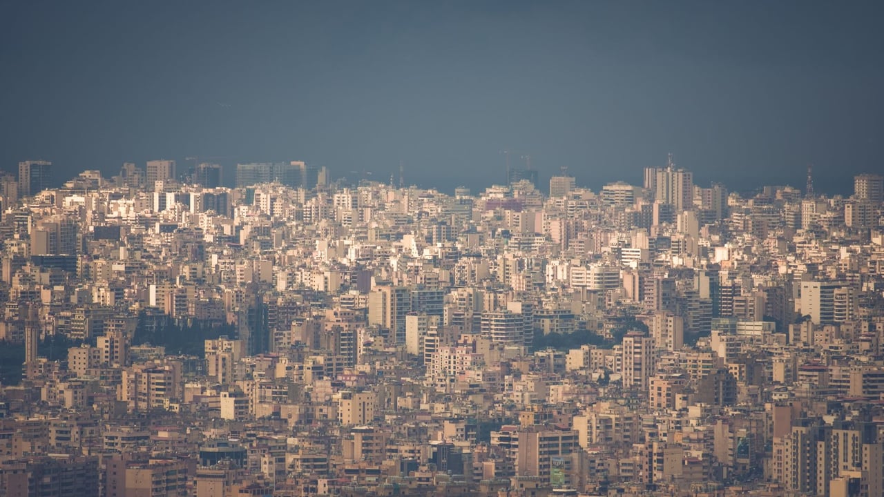 A sprawling view of Beirut's densely packed buildings under a foggy sky, highlighting urban density.