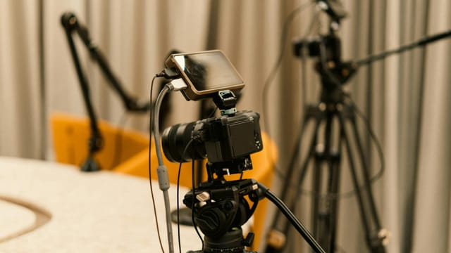 A professional studio with cameras, microphones, and other equipment ready for recording or live streaming.