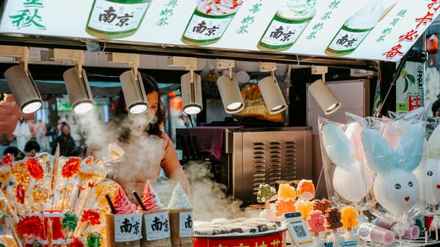 Bustling street food stall in Nanjing, showcasing colorful treats and lively atmosphere.