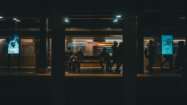 Illustrative image: Blurred motion of subway at New York City station capturing urban nightlife.