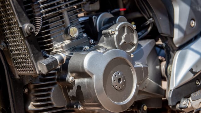Detailed shot of a motorcycle engine showcasing intricate parts and craftsmanship.