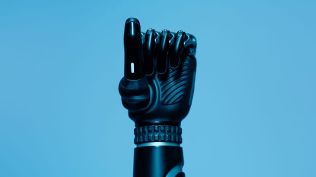 Close-up of a prosthetic arm in a vibrant blue setting, showcasing advanced technology.