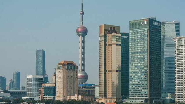 A stunning view of Shanghai's Pudong skyline with the iconic Oriental Pearl Tower and modern skyscrapers.