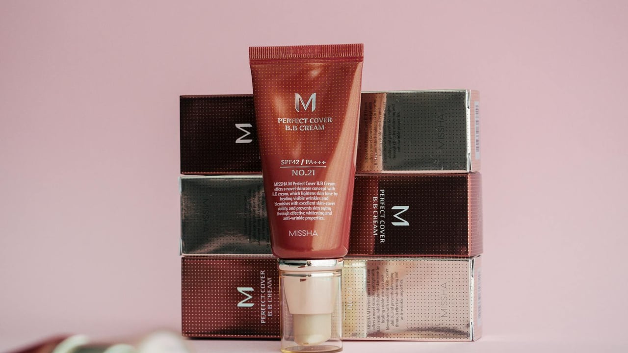 Stylish display of Missha Perfect Cover BB Cream on pink background with packaging.