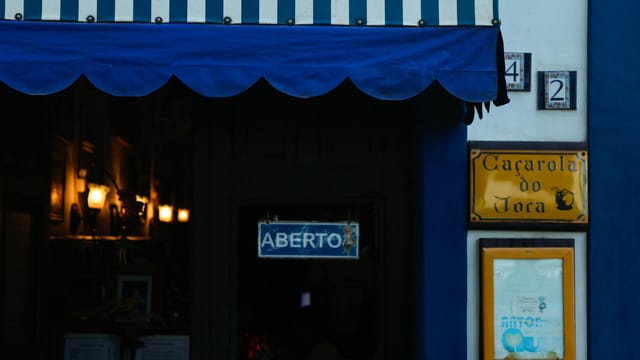 Cozy restaurant entrance with a striped awning in Antonina, Brazil.