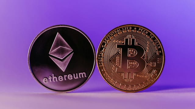 Close-up of Ethereum and Bitcoin coins symbolizing cryptocurrency and blockchain technology against a purple backdrop.