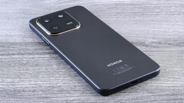 Close-up of a modern smartphone with a sleek design on a wooden surface.