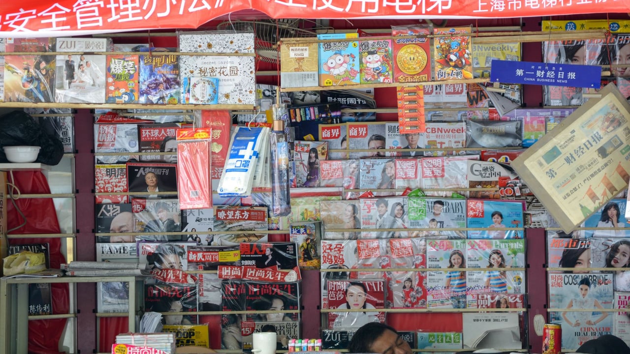 Vibrant newsstand in China displaying a variety of magazines and newspapers.