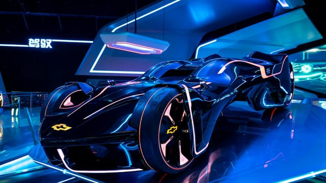 Sleek, illuminated futuristic sports car showcased in a modern indoor exhibit in Shanghai, China.