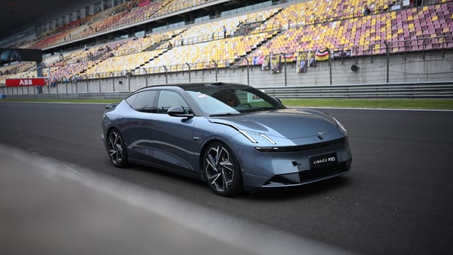 Stylish modern car parked on an empty Shanghai racetrack during the day.