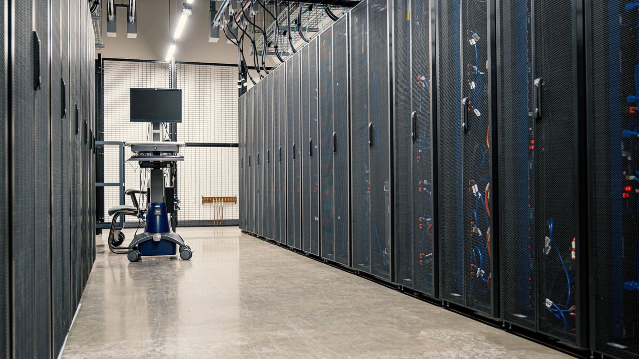 Steel framework cabinets housing servers networking devices and cables in contemporary equipped data center
