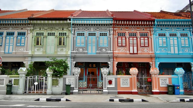 Vibrant facades of historical shophouses on Koon Seng Road in Singapore, showcasing Peranakan architecture.