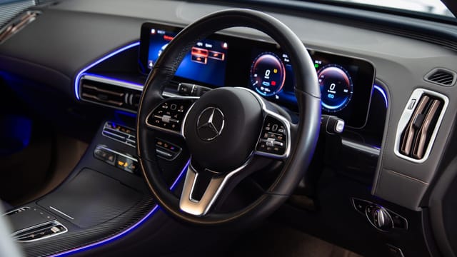Close-up view of a luxury Mercedes-Benz car interior featuring a sleek dashboard and modern technology.