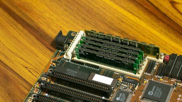 Detailed image of a vintage computer motherboard with RAM sticks.