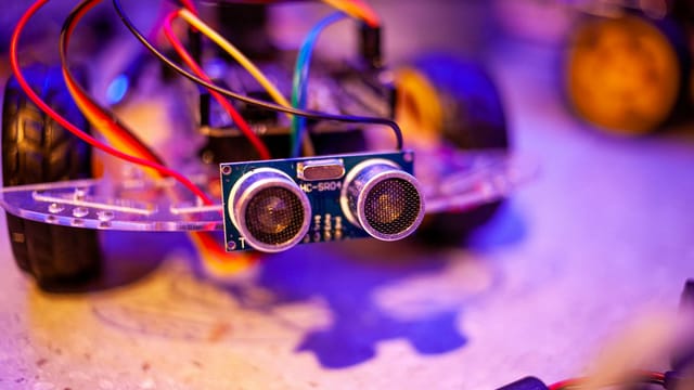 Detailed view of a robotic vehicle component showcasing wires and sensors.