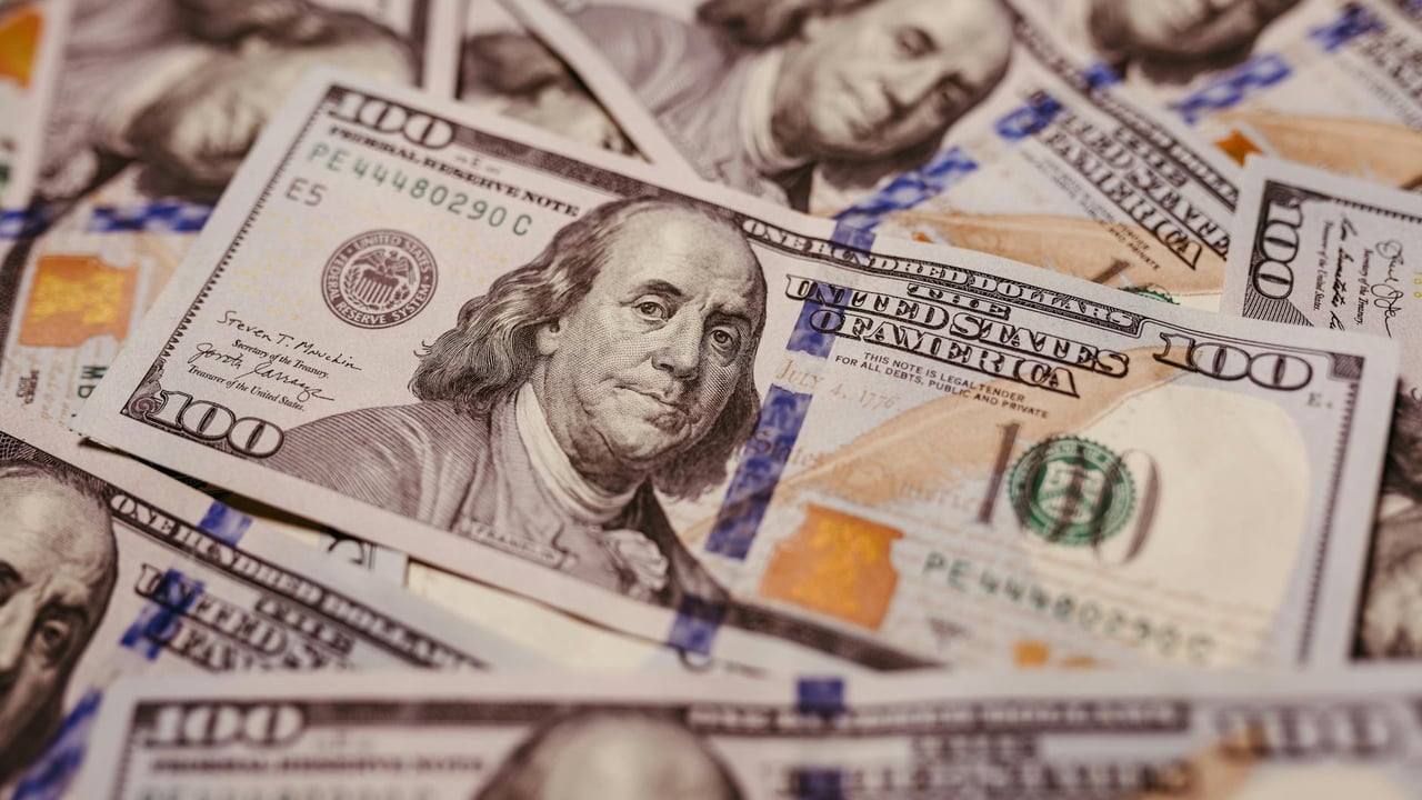 Pile of 100 dollar bills depicting wealth and financial success in close-up view.