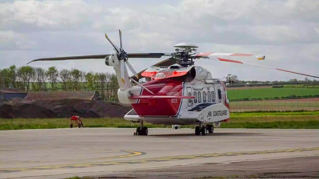 HM Coastguard helicopter on runway in Kingston upon Hull, ready for rescue operations.