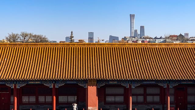 Beijing's traditional architecture contrasts with modern skyscrapers, capturing historical and contemporary merging.