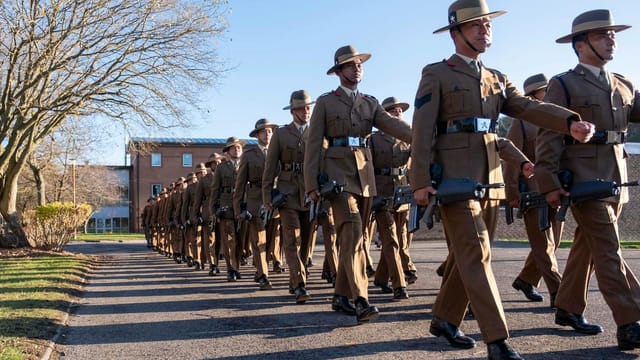 Gurkha soldiers in uniform marching in formation outdoors at Catterick, UK.