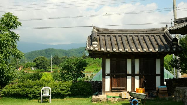 Charming traditional Korean house in a serene countryside setting, ideal for relaxing experiences.