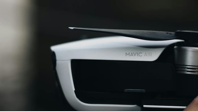 Detailed close-up of a DJI Mavic Air drone, highlighting the propeller and sleek design.