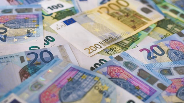 Close-up of Euro banknotes in different denominations, symbolizing wealth and finance.