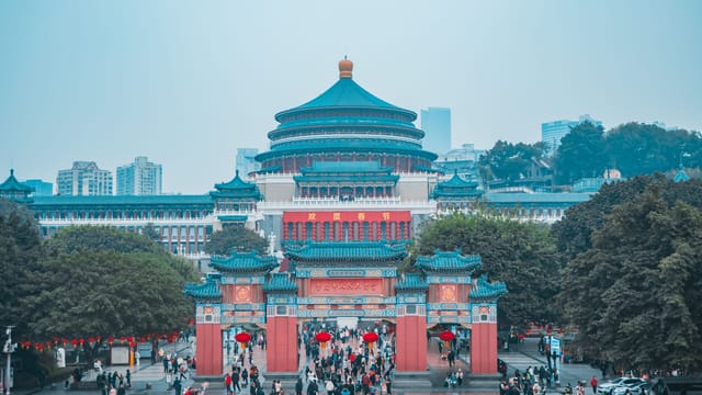 Captivating view of Chongqing's Great Hall of the People with vibrant city life.