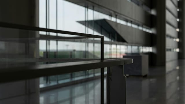 Sleek modern hallway in Shanghai featuring expansive glass windows and contemporary architecture.