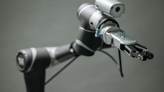 Close-up view of a robotic arm equipped with a video camera, showcasing modern technology.