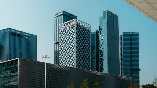 Panoramic view of Shenzhen's modern skyscrapers under a clear blue sky.
