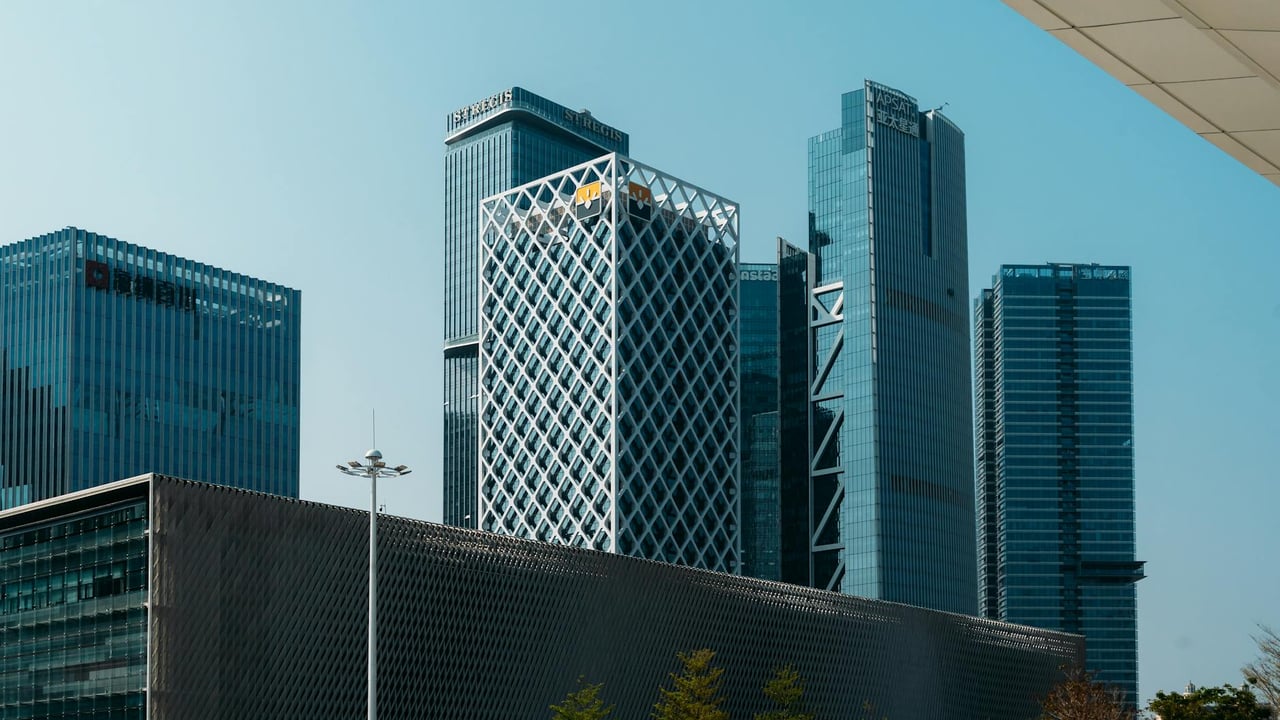 Panoramic view of Shenzhen's modern skyscrapers under a clear blue sky.