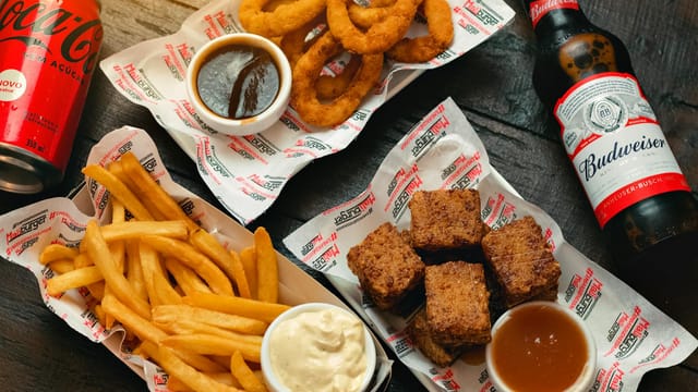 An appetizing assortment of fried foods with soft drinks, perfect for a casual meal.