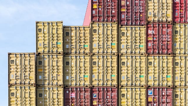 Colorful stacked shipping containers at Hamburg port, showcasing global trade and logistics.