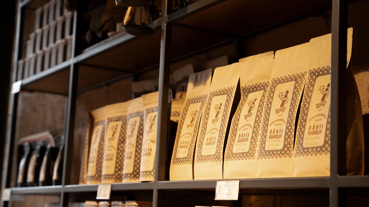 Artisan coffee bags neatly arranged on rustic shelves in a cozy shop setting.