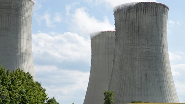Cooling towers of Dukovany nuclear power plant with steam on a clear day.