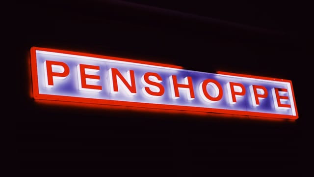 Bright blowing signboard with colorful neon light placed in darkness in night time