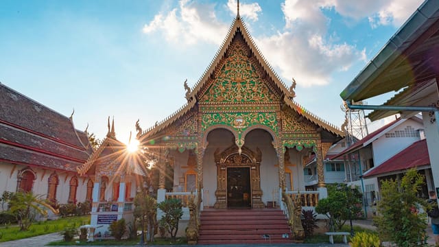 Beautiful ornate temple facade with sunburst at Wat Chiang Man, showcasing traditional Thai architecture.
