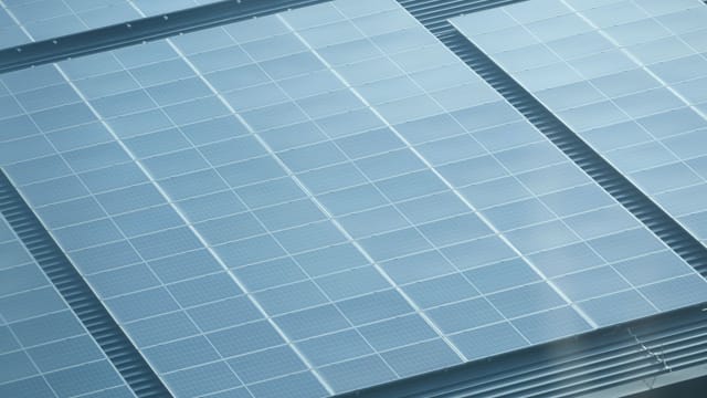 Illustrative image: Detailed view of solar panels installed on a rooftop, showcasing green energy.