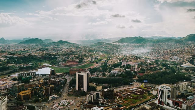 A captivating aerial view of the sprawling cityscape of Yaoundé, Cameroon, under a dramatic sky.