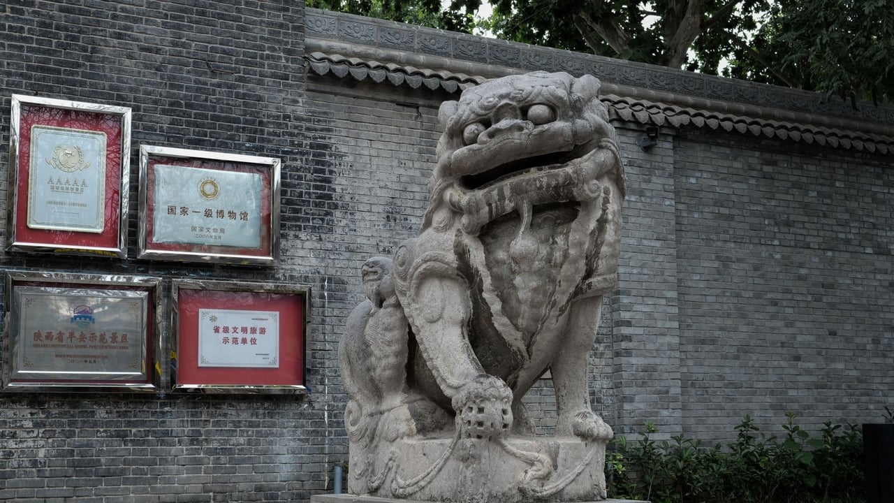A detailed view of a traditional Chinese stone lion statue in Xi'an, Shaanxi Province.
