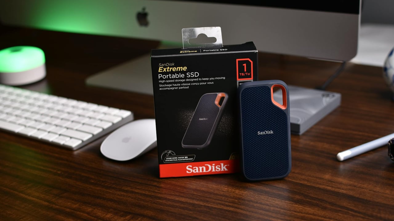 SanDisk Extreme Portable SSD on a modern office desk with iMac setup.