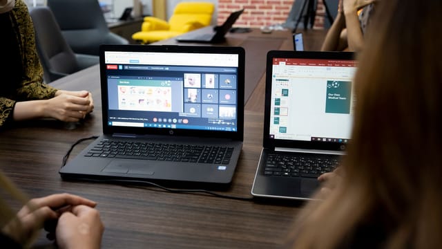 Team discusses projects during a virtual and in-person meeting in a Dubai office.