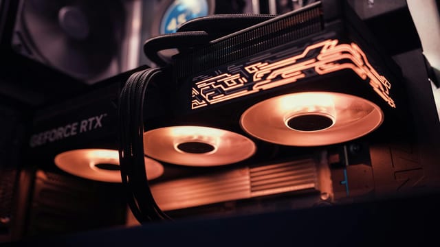 Detailed image of a GeForce RTX GPU with glowing LED lights inside a computer case.