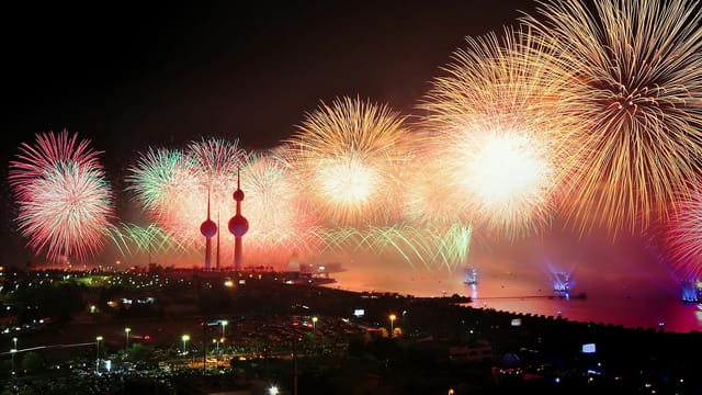 Colorful fireworks illuminate Kuwait Towers, celebrating a night of joy and festivities.