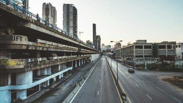 A deserted road in Beirut flanked by tall buildings, showcasing urban architecture.